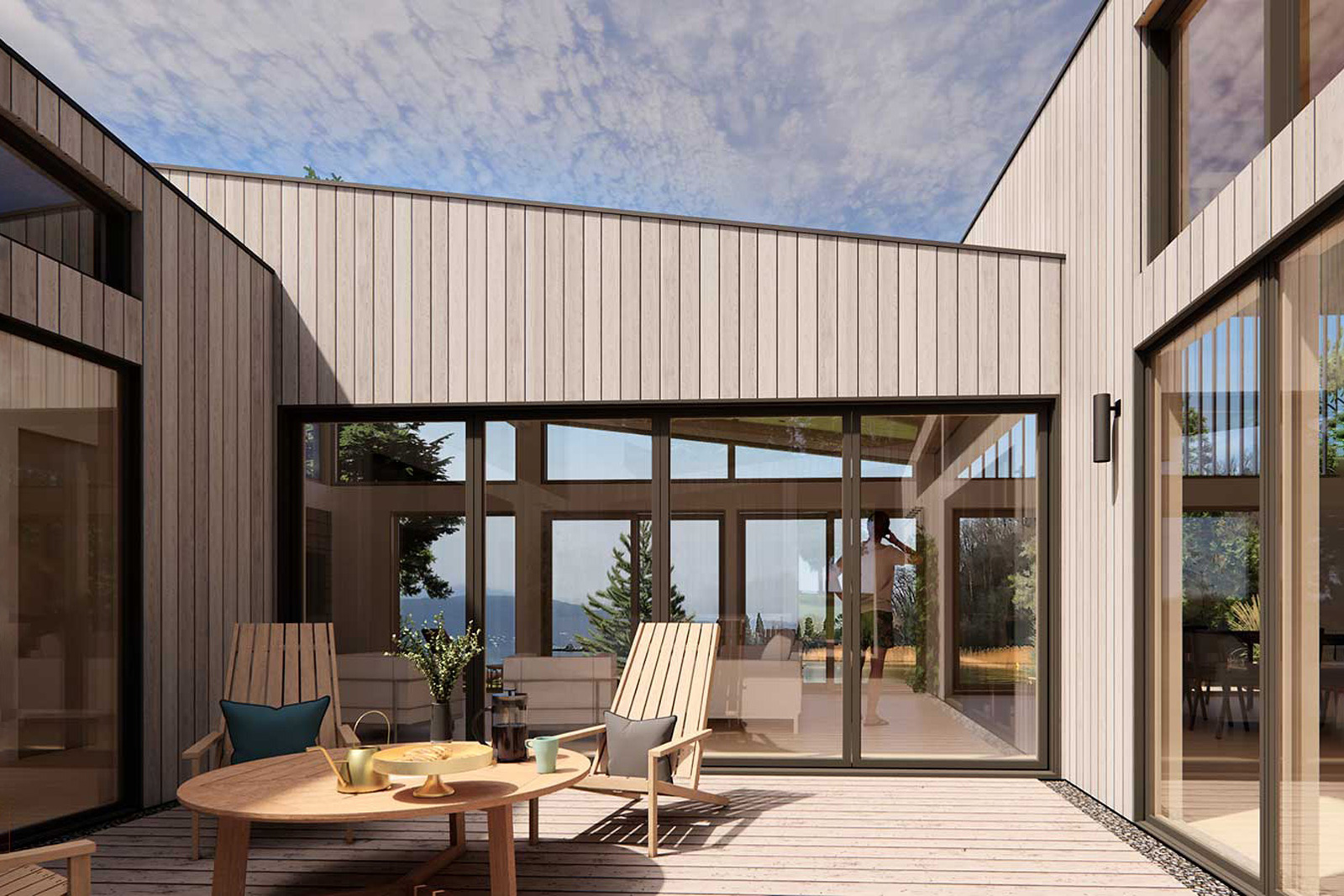 Skycatcher-Michigan-Lakehouse8a View of Skycatcher’s indoor–outdoor connection featuring expansive sliding glass doors opening onto a deck with lounge seating and views to the lake.